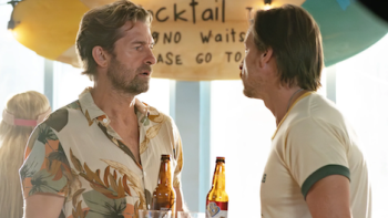 R.J. Decker TV show screenshot 2: Aloysius “Wish” Aiken talks to R.J. Decker while holding a tray of beer bottles