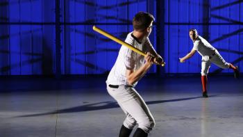 Science of Stupid TV show screenshot: A baseball player pitches to a waiting batter inside a warehouse.