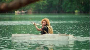 Celebrity Bear Hunt TV show screenshot 1: Mel B Looks over her shoulder, scared, as she paddles a canoe in a river in Costa Rica.