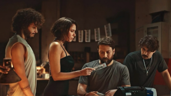 Franklin TV show screenshot 1: Three men and a woman looking at a work station with $100 dollar bills