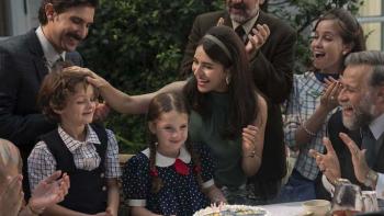 No One Saw Us Leave TV show screenshot: A dark-haired woman and a dark-haired man celebrate at a birthday party with children and family members