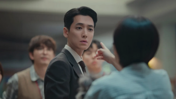 Pro Bono TV show screenshot: An East Asian man in a suit is getting pointed at by a short-haired woman in the foreground
