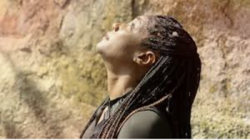 Tiffany Haddish Goes Off TV show screenshot: Close up of Tiffany Haddish looking up in front of some mountains.