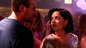 Sexy Beast TV show screenshot 1: Deedee and Gal stand close together in a night club in dressy clothing