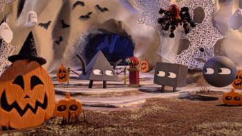 Shape Island: Creepy Cave Crawl. Triangle, Square, and Circle stand in front of the cave, decorated with Halloween decorations like a jack-o-lantern and bats.