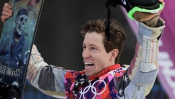 Shaun White: The Last Run TV show screenshot 2: Shaun White holds helmet and snowboard up while celebrating run at Sochi Olympics. 