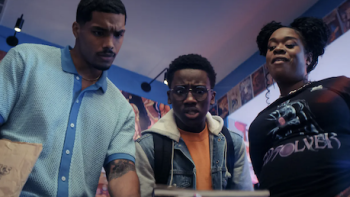 Side Quest TV show screenshot 1: Two men and a woman look down at something. 