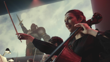 Side Quest TV show screenshot 2: A woman plays the cello in orchestra in time to images from Mythic Quest.