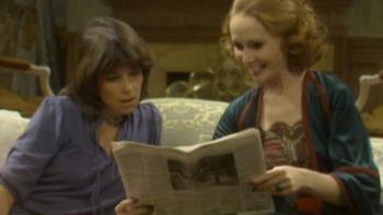 Soap: Eunice and Jessica sit together on an elegant living room couch, looking at a story in a newspaper