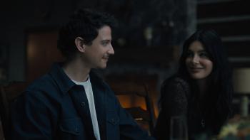 Adam DiMarco and Camila Morone. DiMarco wears a blue jacket and white t-shirt. Morrone wears a dark sweater.