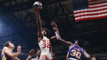 Soul Power: Julius "Dr. J" Erving soars over competitors for a lay-in