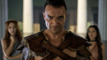 Spartacus: House of Ashur screenshot 1: Ashur stares forward with Hilara and Messia behind him. 