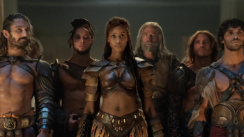 Spartacus: House of Ashur screenshot 2: Achilia stands flanked by gladiators of the ludus.