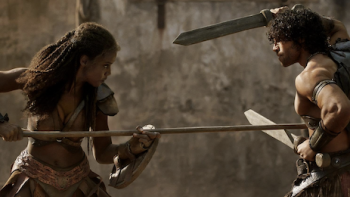 Spartacus: House of Ashur screenshot 3: Achilia holds spear and fights Tarchon at the ludus.