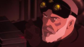 Sam, with goggles raised on forehead, pointing fingers.