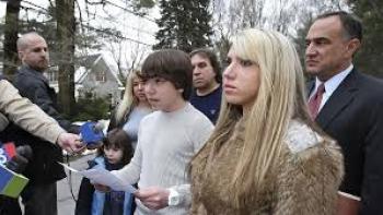 Spy High TV show screenshot #1: A teen addresses the media, surrounded by others