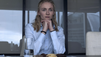 Steal TV show screenshot 1: Zara Dunne stares out a window in front of plate of cookies. 