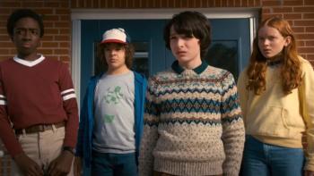 Stranger Things Season 2 TV show screenshot 3: Lucas, Dustin, Mike and Max stand together looking at something off camera