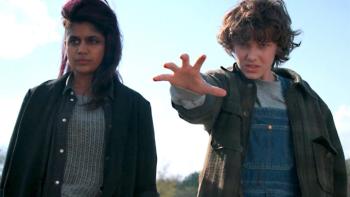 Stranger Things Season 2 TV show screenshot 2: Kali and Eleven stand together in an outdoor shot; Eleven extends her hand in front of her