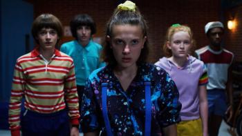 Stranger Things 3 TV show screenshot 1: Will, Mike, Eleven and Max face the camera, looking serious