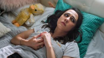 Such Brave Girls TV show screenshot 1: Kat Sadler lies in bed while picking at her fingers.