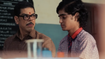 Super Subbu TV show screenshot 2: Cuckoo sitting next to, and sternly looks at, 15-year-old Subbu in a classroom.