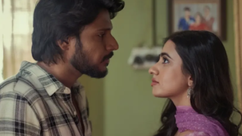 Super Subbu TV show screenshot 3: Subbu and woman face each other intensely in a room with a framed photo behind them.