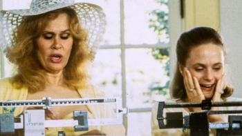 Tales of the City TV Show: Two women stand on side-by-side medical scales; one looks happy with her scale's reading, the other looks shocked. 