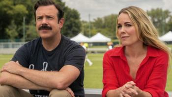 Ted Lasso Season 4: Ted and Michelle sit beside each other on bleachers; Ted has his arms crossed and they look serious