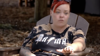 Teen Mom: The Next Chapter TV show  screenshot 2: Catelyn sits in lawn chair wearing black rocker shirt and red died hair. 
