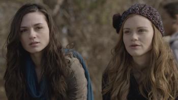 Two young White women with long hair, one wearing a crocheted knit cap