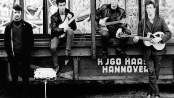 The Beatles Anthology TV show screenshot 1: Ringo Starr, George Harrison, John Lennon, and Paul McCartney standing together in Liverpool.