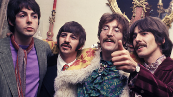 The Beatles Anthology TV show screenshot 2: Paul McCartney, Ringo Starr, John Lennon, and George Harrison in a group picture in colorful outfits. 