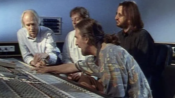 The Beatles Anthology TV show screenshot 3: Manager George Martin with Paul McCartney, Ringo Starr, and engineer in recording studio. 