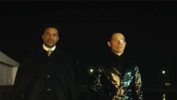  (From L-R) Jeremy Pope and Anthony Ramos stand outside. Pope wears a black coat; Ramos wears a black leather coat.