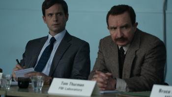 The Bombing of Pan Am 103 TV show screenshot 2: Patrick J. Adams and Eddie Marsan sit at a table with name cards. 