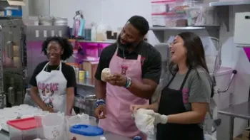 The Cupcake Guys TV Show: Michael Griffin, a black former NFL player, decorates cupcakes with two women employees with brown skin
