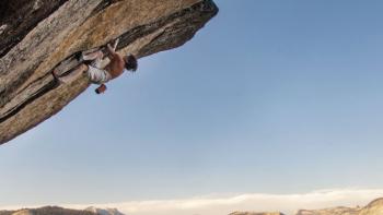The Dark Wizard TV show screenshot 2: Dean Potter solo climbing nearly upside down on a cliff ledge.