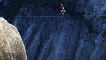 The Dark Wizard TV show screenshot 3: Dean Potter wears red while highlining between two cliff edges.