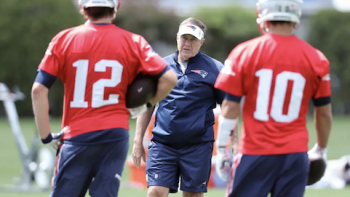 The Dynasty: New England Patriots screenshot 2: Players face Coach Belicheck wearing red jerseys.
