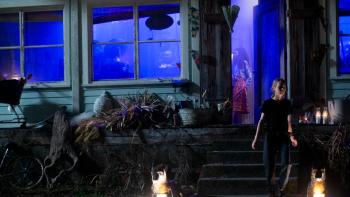 The First TV Series: Denise (Anna Jacoby-Heron) runs out of a house lit with an eerie blue light. 