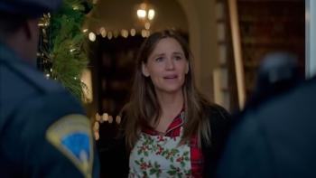  The Five-Star Weekend TV show screenshot 3: Garner stands in front of two police officers. She wears an apron.