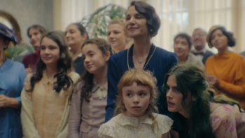 The House of the Spirits screenshot 2: The del Valle family members smiling while Rosa whispers something to Clara.