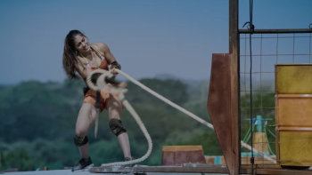 A woman pulls on a rope during a challenge