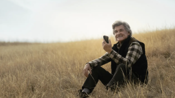The Madison TV show screenshot 2: Preston Clyburn in plaid shirt sitting on grassy hillside