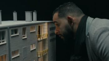 The Outreau Case screenshot 3: Someone looks inside a mock up of 