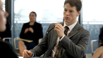 The Rainmaker: Milo Callaghan sits among other lawyers in a boardroom. 