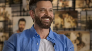 The Roshans TV show screenshot 1: Hrithik Roshan wears open blue shirt over white t-shirt. 