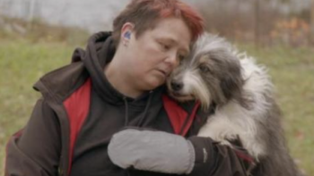 The Secret Life of Dancing Dogs screenshot 2: Marianne Elis Methi outside hugging a gray and white dog.  