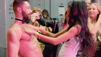 The Secret Lives of Mormon Wives screenshot 3: A Momtok member rubs oil on a bare stripper's chest. 